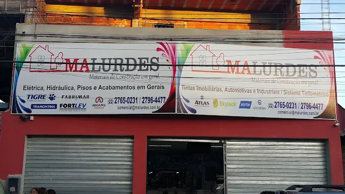 Fachada vermelha da Malurdes com duas placas, uma de materiais de construção e outra de tintas
